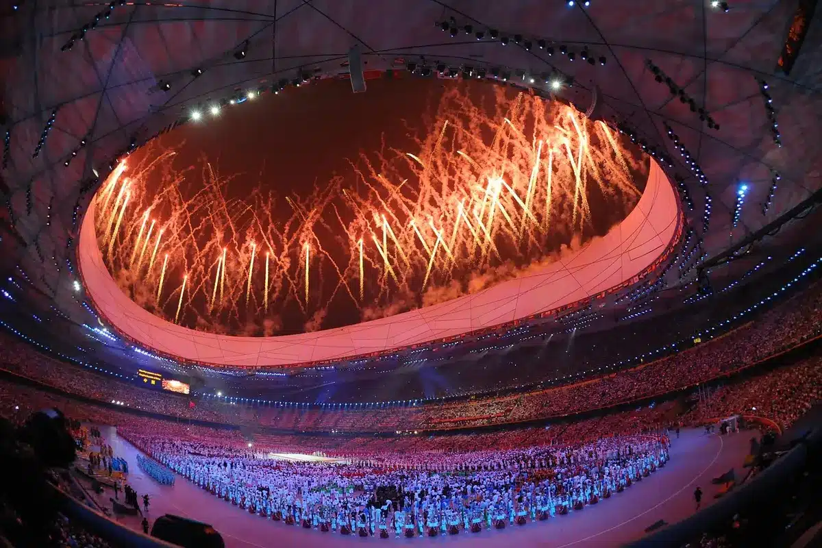Silhouette of a person appearing to throw a drink in an arena