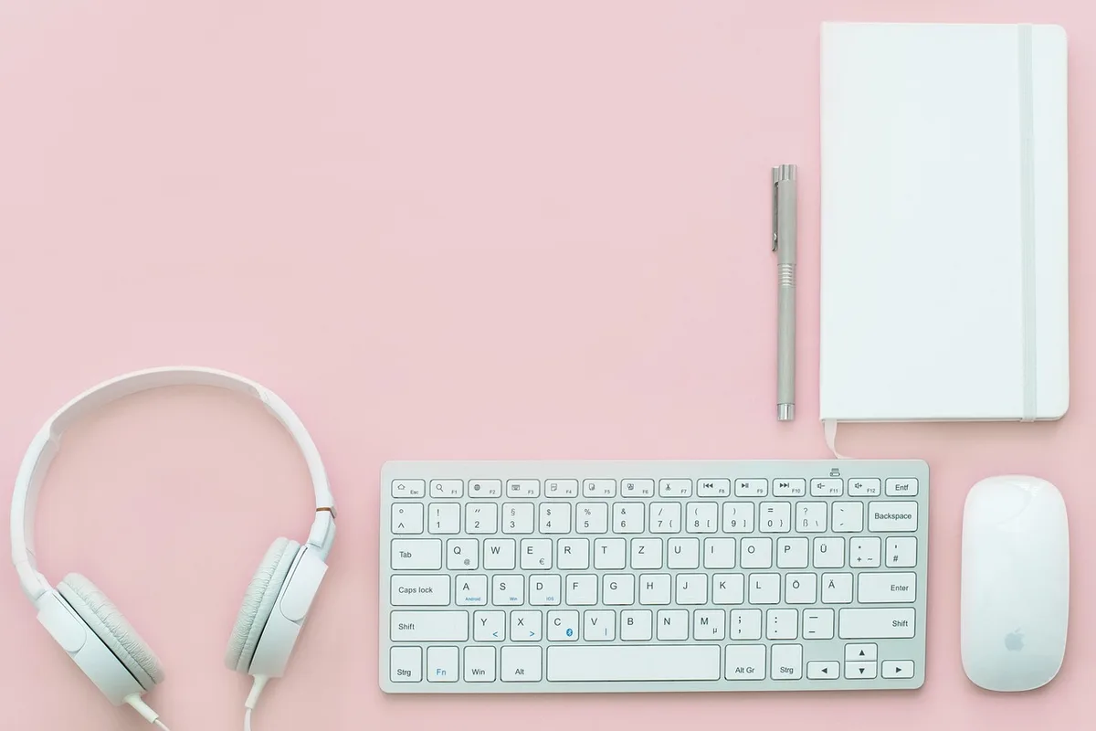 Journalist using laptop and headphones to transcribe an interview