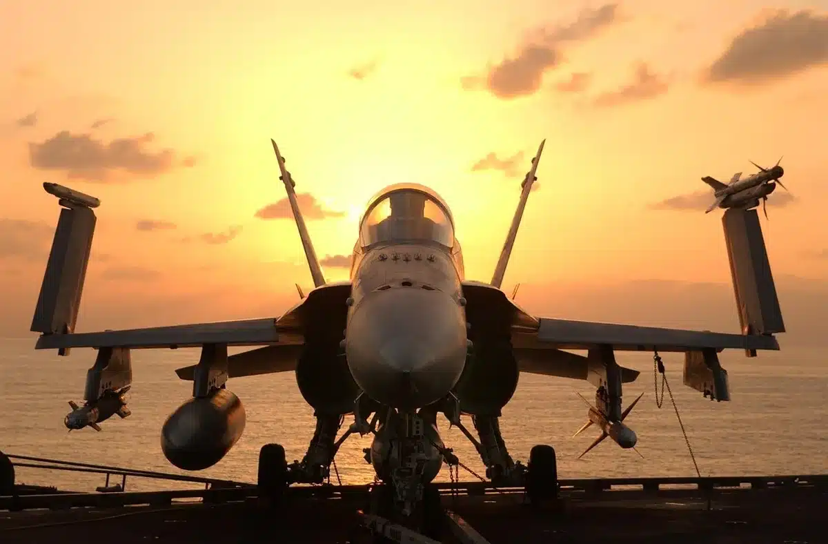 Anonymous official speaking on a carrier flight deck with sailors listening