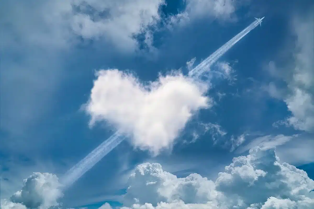 Small aircraft releasing particles into darkening clouds during cloud-seeding operation