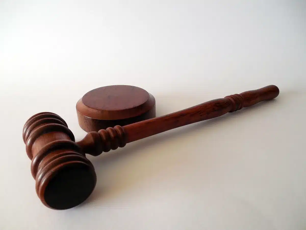 Gavel and legal documents beside a calculator representing disputes over revenue calculations