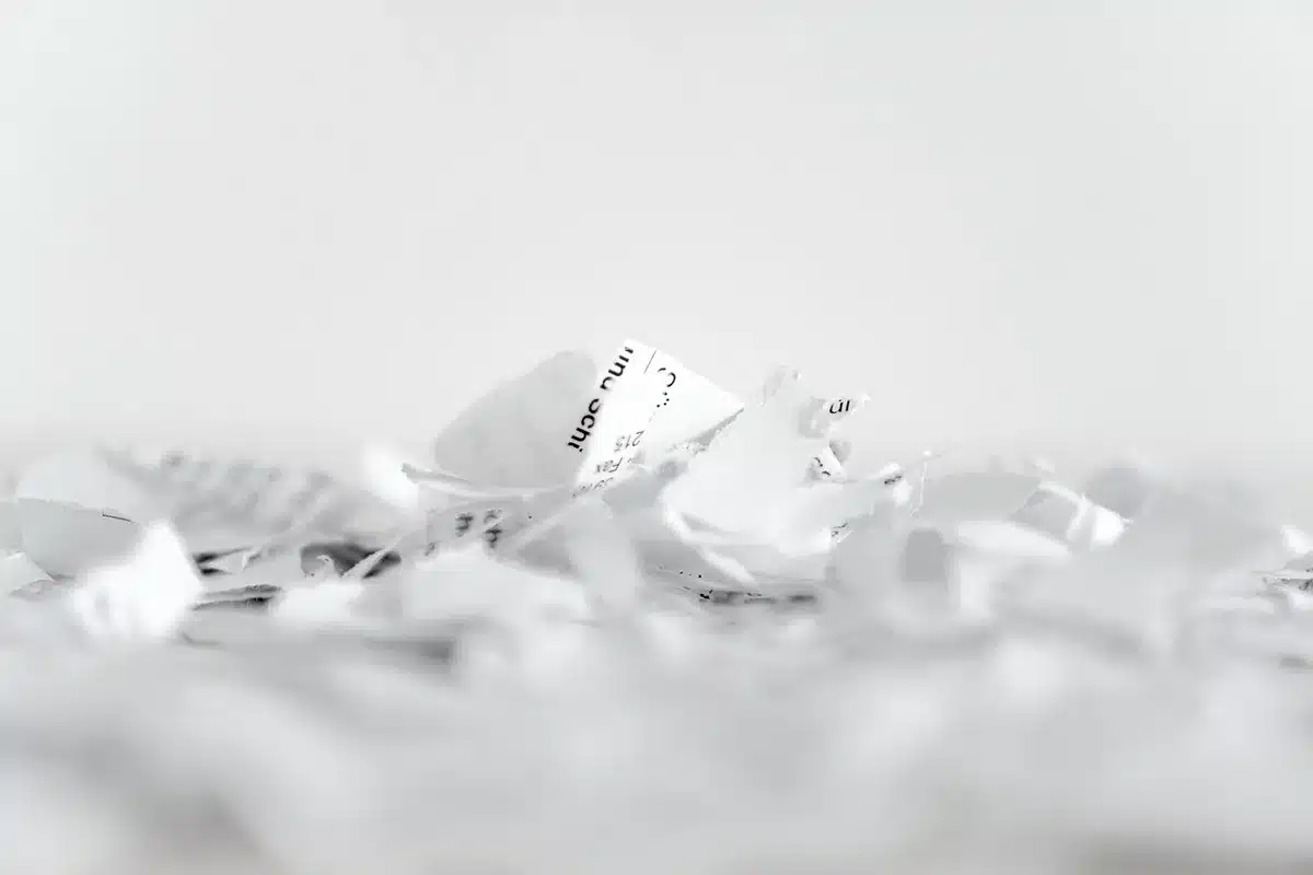 Stack of confidential witness statement folders and court papers on a table