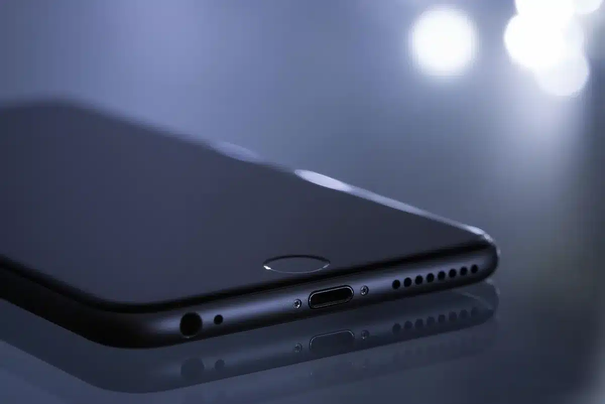 Hands holding a smartphone with notifications, evoking privacy and data seizure issues