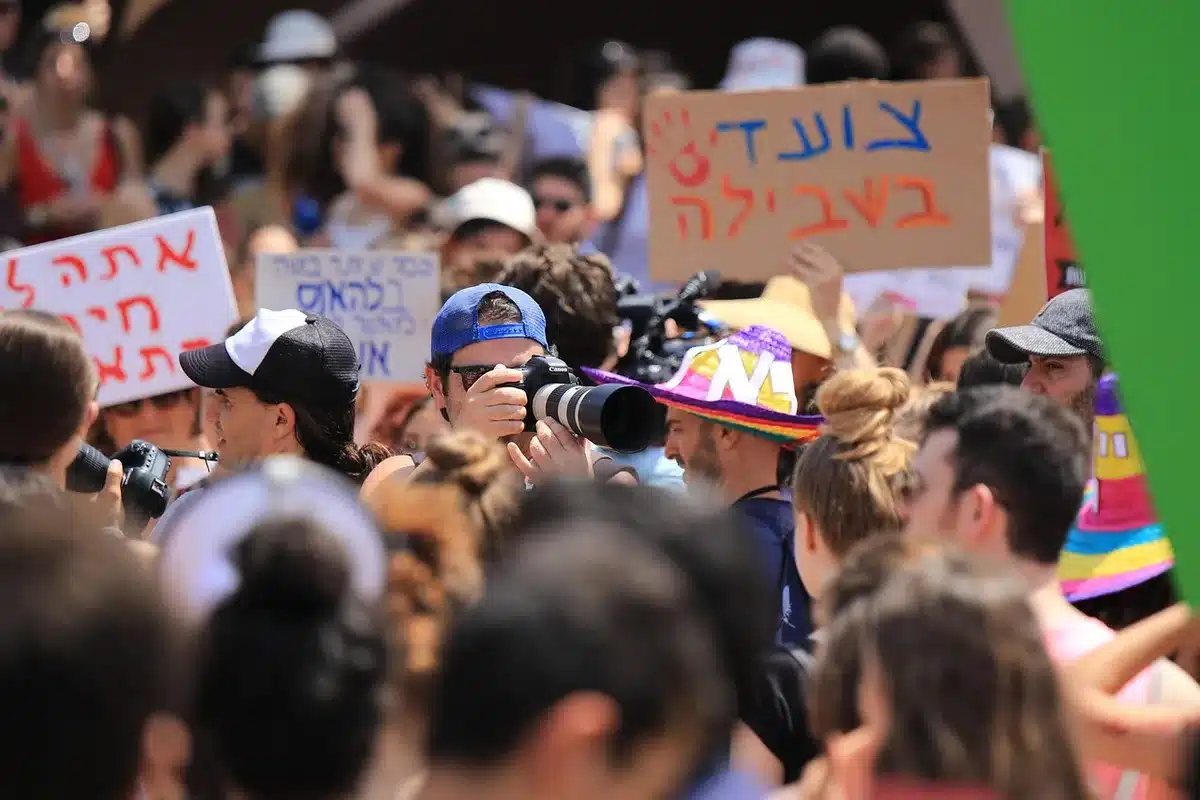 Organizers speaking to a crowd with a megaphone during a protest