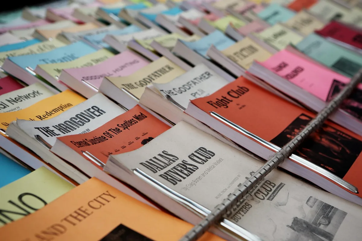 Stack of film reviews and cinema tickets on a table