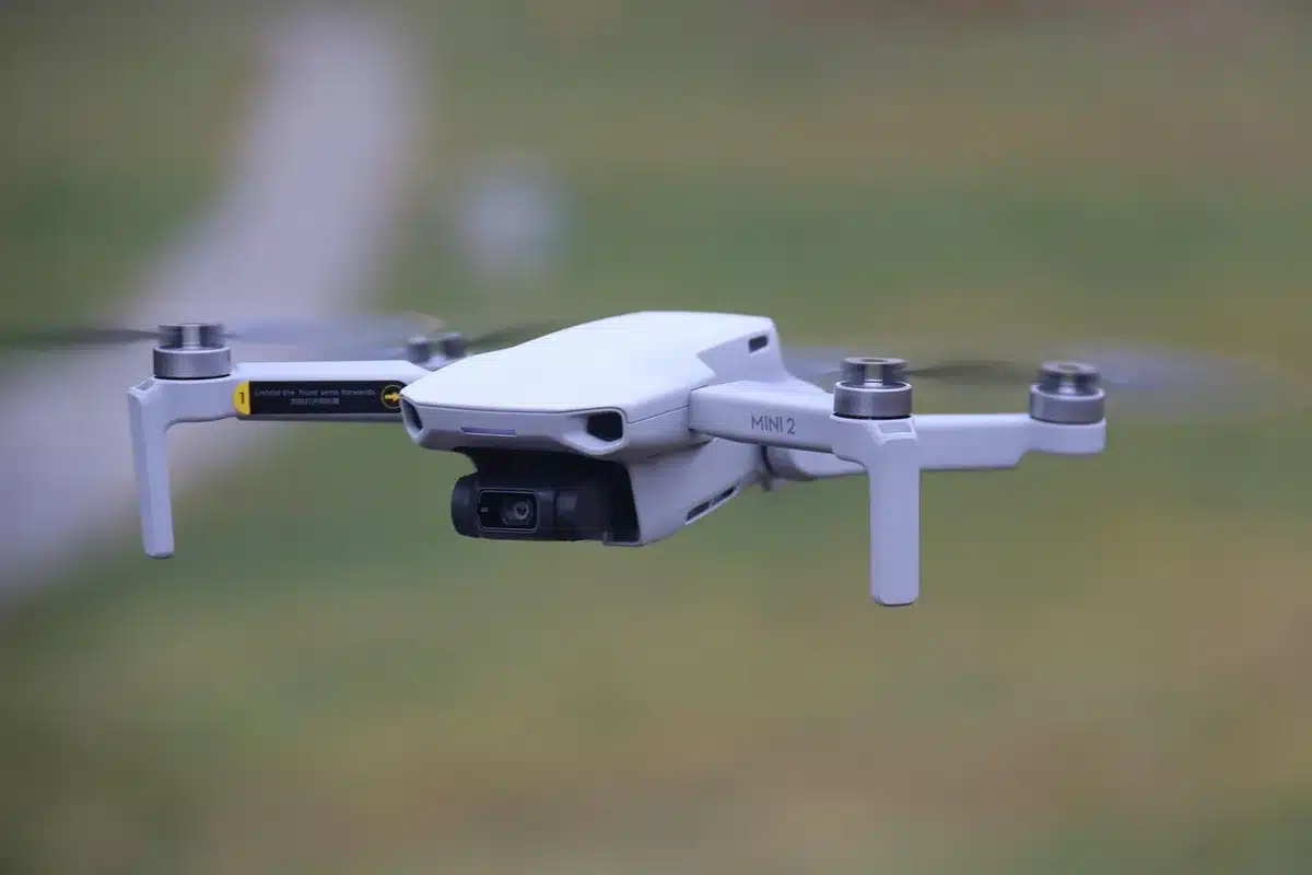 A police drone and a street camera symbolizing modern surveillance tools