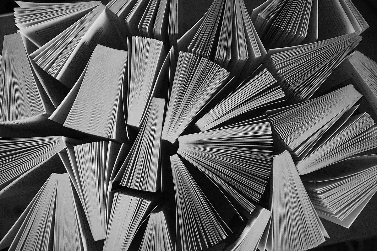 Stack of loan application forms and folders representing backlog
