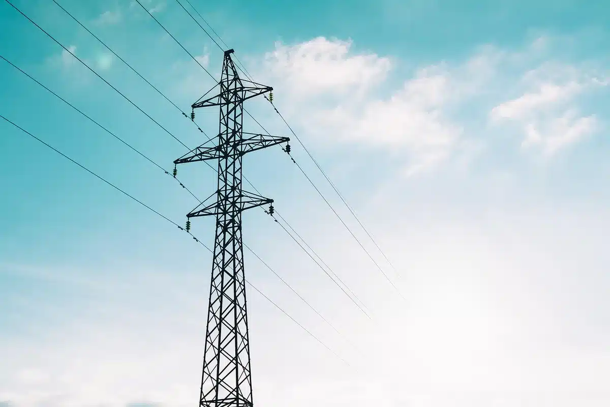Coal power plant stacks emitting steam near transmission lines